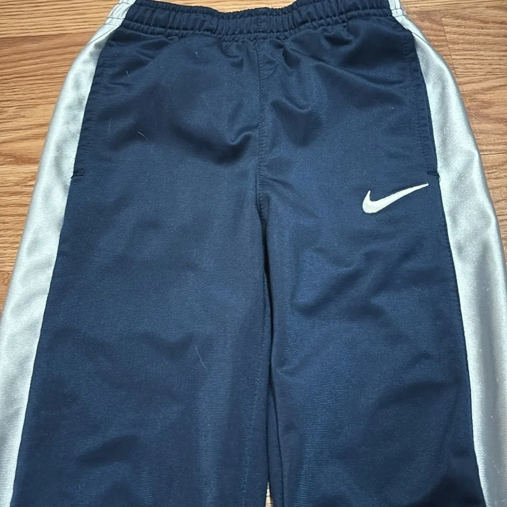 Size 6 Nike pants- blue with silver stripes. Athletic pants